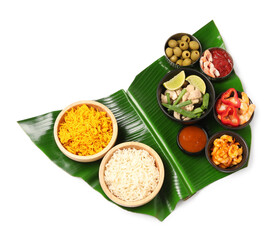 Piece of banana leaf with different food and sauce isolated on white, top view. Healthy eco serving