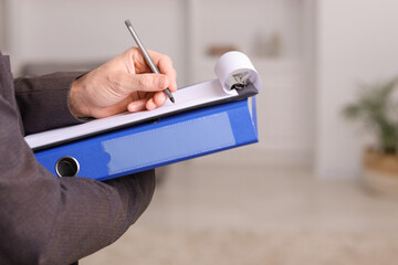 Real estate appraisal. Inspector with clipboard conducting property valuation indoors, closeup....
