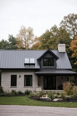 Obraz premium A contemporary house design nestled in a serene environment, embraced by majestic trees adorned in vibrant autumn colors, located in a peaceful rural area