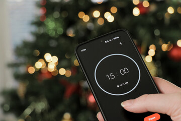 A phone with a black and white 15-minute timer to study with the pomodoro method on a blurry...