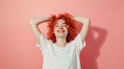 Fototapeta premium portrait of a smiling girl with red curly hair, pink background 