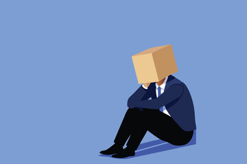 A businessman sits on the floor with a box on his head, depicting failure and disappointment.
