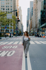 Woman walking in urban city street wearing stylish checkered suit