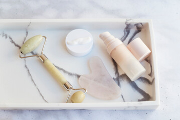Fototapeta premium Anti-Age Face Cream and Jade Roller in Marble Plate 