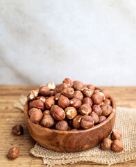Raw hazelnuts in a wooden bowl
