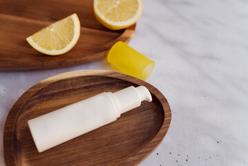 Vitamin C face cream in a wooden tray with lemon slices