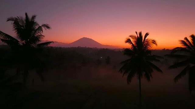 Beautiful sunrise scenery in Bali covered with mountains and mist aerial drone shot, Indonesia