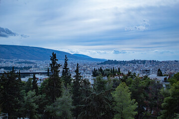 Mesmerizing view from the mountain to the city of Athens, wild mountains, clouds, blue sky, Greece