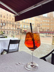 Cocktail aperol spritz on a table in restaurant  in Siena, Italy