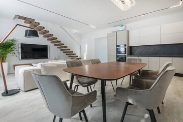 Apartments with an elegant interior design. Bright room decor, stylish furniture. .Kitchen set and living room area with upholstered furniture.