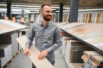 Man choosing flooring in hardware store