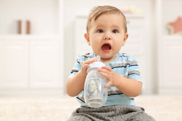 Little baby with money in bottle at home. Space for text