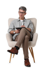 Professional psychologist with clipboard sitting on chair against white background