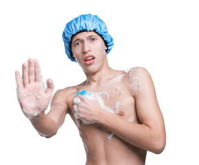 Man with shower cap and mesh sponge making stop gesture on white background