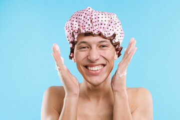 Man in shower cap on light blue background