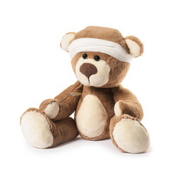 Teddy bear with bandage and thermometer isolated on white