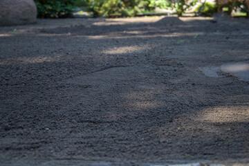 Leveling the soil before planting a lawn.