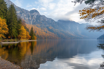 Obraz premium Scenic autumn landscape with calm lake reflecting mountains and trees in tranquil setting