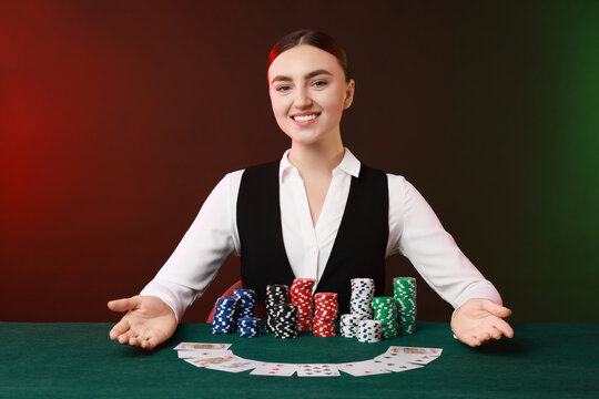 Professional croupier with casino chips and playing cards at gambling table on color background - Powered by Adobe