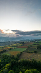 Vertical shot of sunset in the countryside with the city of Cartago in the background with a beautiful summer sky