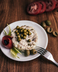Creamy Salad with Green Peas and Decorative Garnishes on Wooden Surface