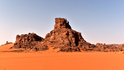 Rock formations in Tadrart Rouge, Tassili N'Ajjer National Park. Sahara desert, orange sand and rocks. Holidays and travel in Algeria. Sahara, Algeria, Africa.