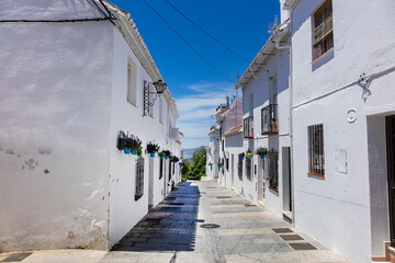 Fototapeta premium Unique white painted village of Mijas (not far from Malaga) - Spanish hill town overlooking the Costa del Sol. Wonderful decoration of the houses in Mijas. Mijas, Andalusia, Spain.