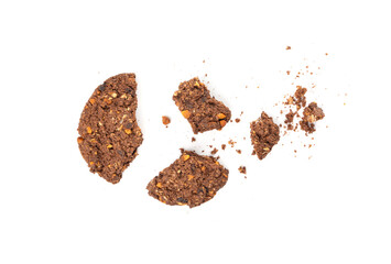 Crumbled chocolate oatmeal cookies isolated, broken cereal oat crackers with nuts