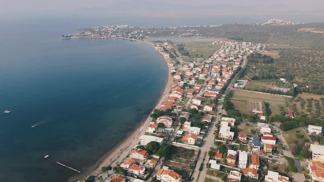 Calm aegean sea beach and coastal houses of sakran town of turkey, aerial view