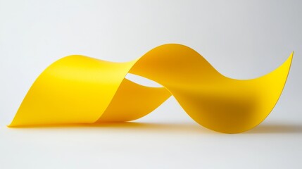 A smooth yellow ribbon twists and flows elegantly across a light background, creating a striking visual element perfect for design projects needing ample copy space