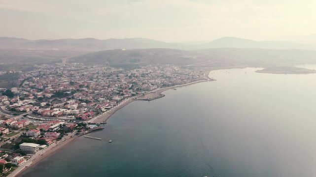 Calm aegean sea beach and coastal houses of sakran town of turkey, aerial view