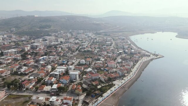 Calm aegean sea beach and coastal houses of sakran town of turkey, aerial view