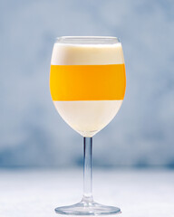 Italian dessert panna cotta with tangerine jelly layer in a glass