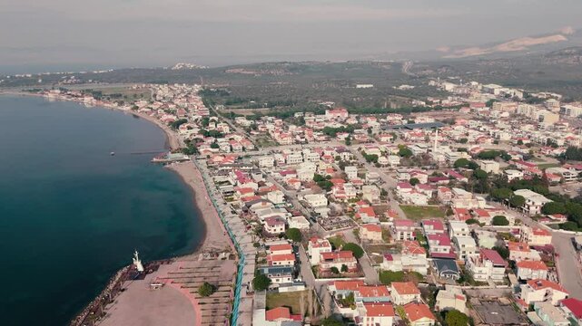 Calm aegean sea beach and coastal houses of sakran town of turkey, aerial view