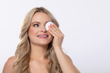 Woman Applying Skincare with a Cotton Pad for Daily Care and Nurturing Her Skin Routine