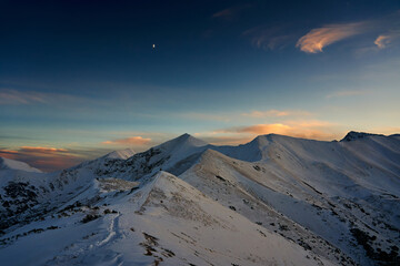 Snow covered mountain tops under the blue sky, wonderful place for vacation in nature. Stunning landscape