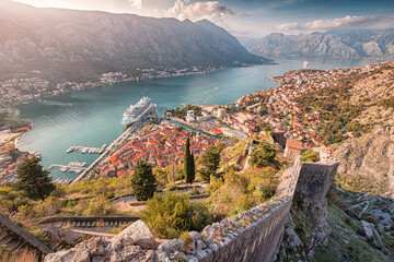 A stunning view of Kotor, Montenegro, with its historic fortress walls, Adriatic Sea, and charming...