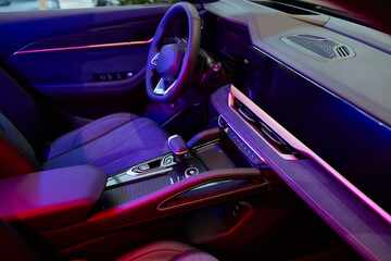 Stylish and Modern Car Interior Design Featuring Carbon Fiber Accents and Ambient Lighting