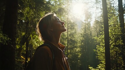 Naklejka premium Young Woman Enjoying Nature in Sunlit Forest with Green Trees