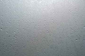 Misted glass background and Detail of water droplets, gloomy gray day. Window and rain outside | Foreground overlay for beauty and skin care products