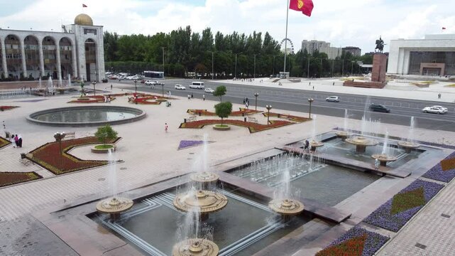 Low aerial shot flying over Ala Too Square in the center of Bishkek, Kyrgyzstan.