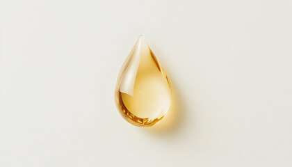 Fototapeta premium Single drop of golden oil isolated on a white background, highlighting purity and luxury