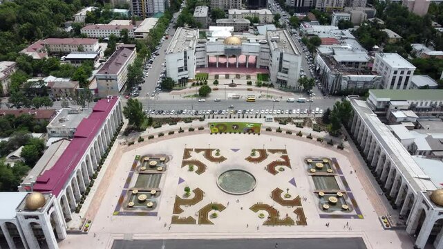 Low aerial shot flying over Ala Too Square in the center of Bishkek, Kyrgyzstan.