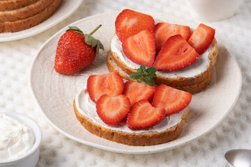 Homemade Crispbread toast with Cottage Cheese and Strawberry on white table