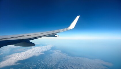 Obraz premium aircraft wing over clear blue sky