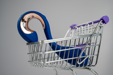Sex toy in miniature shopping cart on white background. 