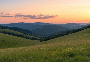 Fototapeta premium Beautiful summer landscape with green grass on the mountain hill and a beautiful sunset sky over the mountains in the background, with copy space for text. high resolution.