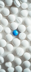 Blue pill surrounded by white pills, healthcare, medicine