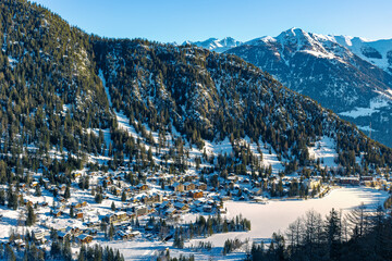 Aerial panoramic view of Champex-Lac on a snowy winter day in Orsieres in the district of Entremont in the canton of Valais in Switzerland