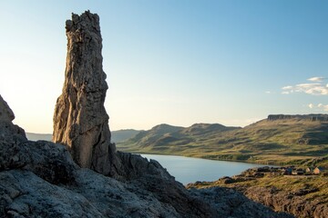 Naklejka premium The iconic view of the Old Man rock spire on Skye island in Scotland, with its unique and dramatic landscape, overlooking traditional Scottish lo scientists . The photo was taken during golden hour to